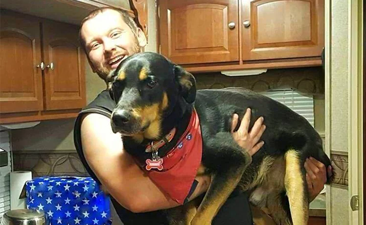 Trucker Josh in his kitchen with his dog, Diesel